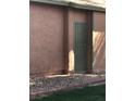 Exterior view of the property with a secured utility access door at 461 N Lamb Blvd # H, Las Vegas, NV 89110