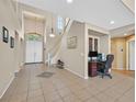 Open foyer with a staircase, tile flooring, and a view of the front door at 8828 Monte Oro Dr, Las Vegas, NV 89131