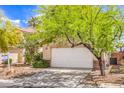 Exterior view of home, showcasing the desert landscaping and garage entrance at 3728 Ashling St, Las Vegas, NV 89129