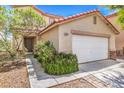 Home exterior with attached garage and desert landscaping in front at 3728 Ashling St, Las Vegas, NV 89129
