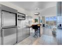 Sleek, stainless steel kitchen with modern appliances and adjacent seating area at 4381 W Flamingo Rd # 1109, Las Vegas, NV 89103