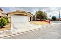 Single-story home boasting a spacious driveway, two-car garage, and well-kept landscaping at 4484 Warbonnet Way, Las Vegas, NV 89147