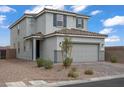 Gray two-story home featuring a two-car garage, landscaping, and a tile roof at 5692 Tinar St, Las Vegas, NV 89113