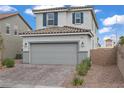 Charming home featuring a gray exterior, tiled roof, and an attached two-car garage at 5692 Tinar St, Las Vegas, NV 89113