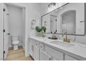 Bright bathroom showcasing a double sink vanity with white cabinets and modern fixtures at 10200 Wood Work Ln, Las Vegas, NV 89135