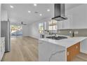 Open kitchen with island, modern countertops, stainless appliances, and a gas range at 10200 Wood Work Ln, Las Vegas, NV 89135