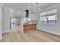 Bright open kitchen with an island, marble countertops, and stainless steel appliances at 10200 Wood Work Ln, Las Vegas, NV 89135