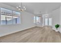 Brightly lit living room has wood flooring and views of the front yard at 10200 Wood Work Ln, Las Vegas, NV 89135