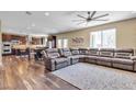 Open-concept living room showcasing hardwood floors and an oversized sofa at 10412 Deer Heights St, Las Vegas, NV 89178