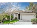 Inviting single-story home featuring a landscaped front yard, neutral paint, and a two-car garage at 10505 Jeremy Ridge Ave, Las Vegas, NV 89144
