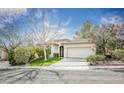 Inviting single-story home featuring a landscaped front yard, neutral paint, and a two-car garage at 10505 Jeremy Ridge Ave, Las Vegas, NV 89144