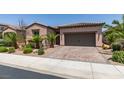 Charming single-story home with a two-car garage and a beautifully landscaped front yard at 1128 Via Della Curia, Henderson, NV 89011