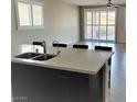 Open concept kitchen with eat-in breakfast bar and large sliding glass doors to the backyard at 1128 Via Della Curia, Henderson, NV 89011