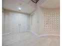 Bright foyer with white tile flooring, double doors, decorative mirrored wall art, and an open staircase at 11534 Glowing Sunset Ln, Las Vegas, NV 89135
