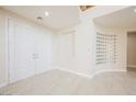 Bright foyer features tile flooring, double doors, decorative mirrored wall art, and an open staircase at 11534 Glowing Sunset Ln, Las Vegas, NV 89135