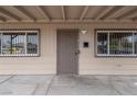 Close-up of front door with security bars on windows and a covered entrance at 1189 Blankenship Ave, Las Vegas, NV 89106