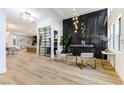 Stunning living room features wood floors, high ceilings, a modern fireplace, and a glass-enclosed wine cellar at 1350 Rossini St, Henderson, NV 89052