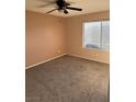 Bright bedroom with carpet flooring and ceiling fan and natural light from the window at 1447 Hialeah Dr # B, Las Vegas, NV 89119