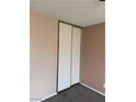 Bedroom featuring double sliding door closet and neutral walls and carpet flooring at 1447 Hialeah Dr # B, Las Vegas, NV 89119