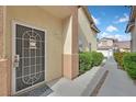 Charming home entrance features a secure storm door and well-maintained walkway at 1453 Blisworth Ct # 102, Las Vegas, NV 89102