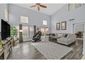 Bright living room boasts soaring ceilings, large windows, and hardwood floors at 1453 Blisworth Ct # 102, Las Vegas, NV 89102