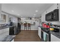 Spacious kitchen with modern appliances, white cabinets, and a breakfast bar seating area at 2111 River City Dr, Laughlin, NV 89029