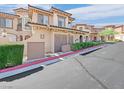 Inviting townhouse with a tile roof, manicured landscaping, and a two-car garage at 24 Via Vasari # 104, Henderson, NV 89011