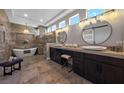 Spa-like bathroom with a soaking tub, dual vanities, and elegant lighting at 2548 Faiss Dr, Las Vegas, NV 89134