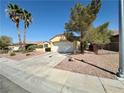 Well-maintained single-story home with desert landscaping, large driveway and a two-car garage at 2558 Grandville Ave, Henderson, NV 89052