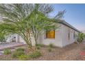 Exterior showcasing desert landscaping and a glimpse of the attached two-car garage at 26 Sun Mirage Ave, Henderson, NV 89011