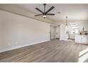 Open-concept living space featuring wood-look flooring and modern ceiling fan at 2629 Blue Reef Dr, North Las Vegas, NV 89032