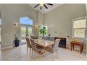 Elegant dining room with high ceilings, tile floors, and large windows providing plenty of natural light at 2708 Port Of Call Dr, Las Vegas, NV 89128