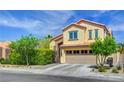 Two-story home with a two-car garage, tile roof, and mature landscaping at 2708 Port Of Call Dr, Las Vegas, NV 89128