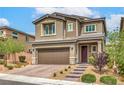 Attractive two-story home featuring a brick driveway, landscaped yard, and an inviting front porch at 2711 Evolutionary Ln, Las Vegas, NV 89138