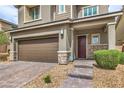 Inviting two-story home showcasing a well-kept front yard and a spacious two-car garage at 2711 Evolutionary Ln, Las Vegas, NV 89138