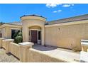 Inviting front entry with decorative turret, covered porch, and well-maintained landscaping at 2713 Rue Toulouse Ave, Henderson, NV 89044