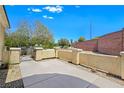 Well-maintained yard area with low wall, offering privacy and curb appeal at 2713 Rue Toulouse Ave, Henderson, NV 89044