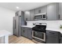 Well-appointed kitchen boasts stainless steel appliances, grey cabinets, and ample counter space at 2724 Spear St, North Las Vegas, NV 89030
