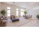 Bright living room features high ceilings, many windows, and adjacent dining area, ideal for entertaining at 2740 Billy Casper Dr, Las Vegas, NV 89134