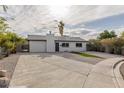 This single-story home features a xeriscaped front yard and a long, paved driveway at 2905 Dogwood Ct, North Las Vegas, NV 89030