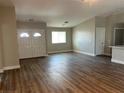 Spacious living room showcasing wood-look floors and a bright entry with arched double-doors at 3016 Mount Charleston Dr, Pahrump, NV 89048