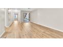 Open living space with light wood floors and a large window at 3676 Renovah St # 102, Las Vegas, NV 89129