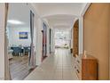 Inviting hallway featuring tiled flooring, decorative columns, and a view into the living spaces at 4432 Vicobello Ave, Las Vegas, NV 89141