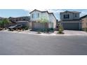 Two-story home shows great curb appeal with a neutral color palette, brick accents, and an attached garage at 4707 Pink Jasper Ct, Las Vegas, NV 89141
