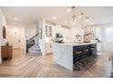 Stunning kitchen with a large center island, quartz countertops, stainless steel appliances and wood look floors at 4707 Pink Jasper Ct, Las Vegas, NV 89141