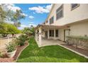 Spacious backyard features a covered patio, green lawn, and well-maintained landscaping with mature roses at 5148 Forest Oaks Dr, Las Vegas, NV 89149