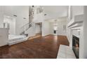 Bright, open living room with wood floors, fireplace, high ceilings and stairway to the 2nd floor at 5148 Forest Oaks Dr, Las Vegas, NV 89149