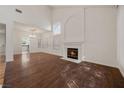 Spacious living room with high ceilings, fireplace, wood floors, and plenty of natural light at 5148 Forest Oaks Dr, Las Vegas, NV 89149