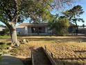 Expansive backyard featuring mature trees, a covered patio, and plenty of room for outdoor activities at 5352 Eugene Ave, Las Vegas, NV 89108