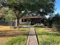 Secluded backyard featuring a charming brick pathway, mature trees, and a cozy outdoor seating area at 5352 Eugene Ave, Las Vegas, NV 89108
